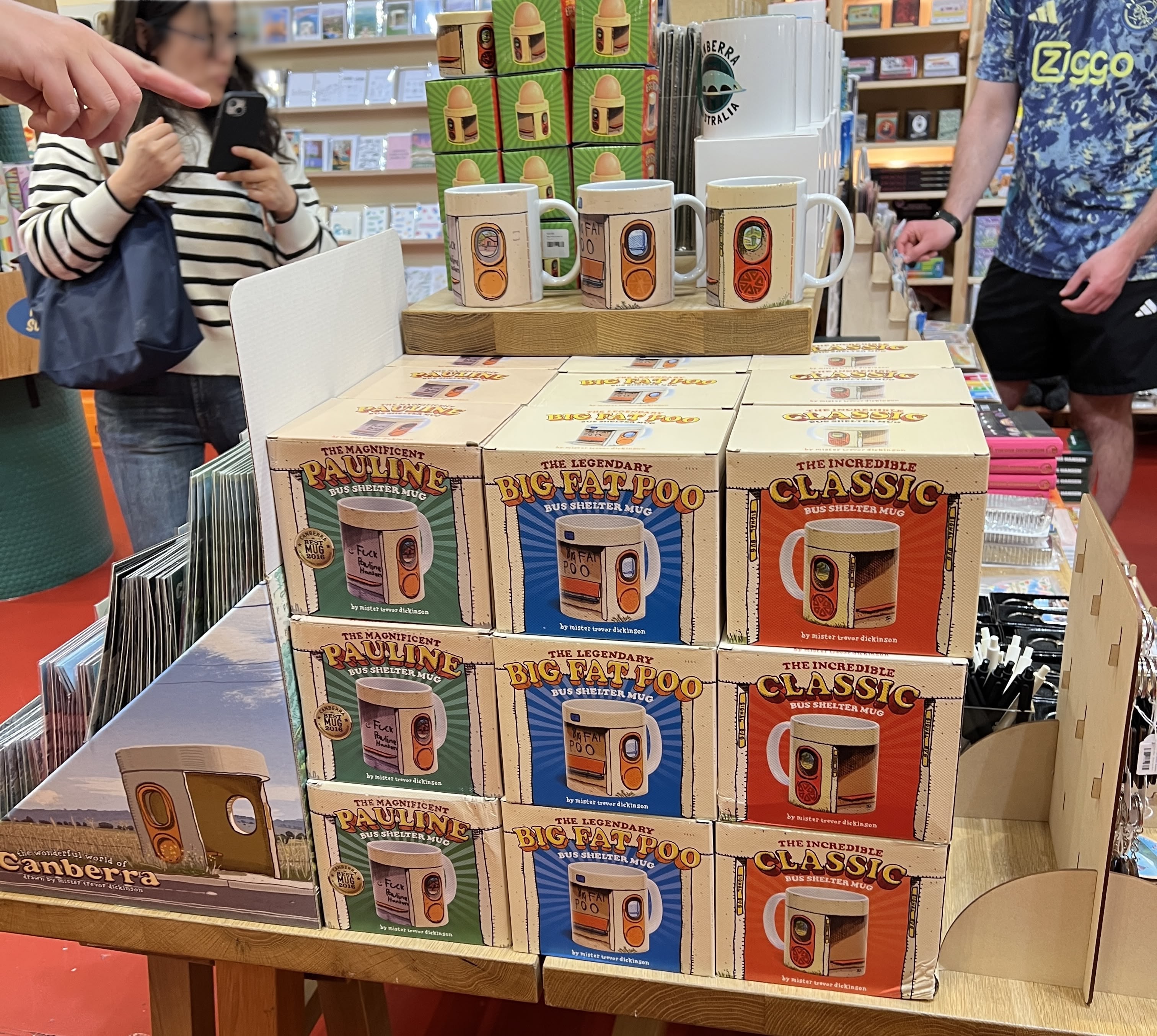 Shop display with boxes of mugs with bus print