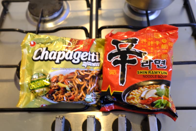 Chapagetti and shin ramyun packets on stove